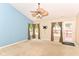 Bright living room features a ceiling fan and glass door to the backyard at 3067 Stilton Dr, Cicero, IN 46034