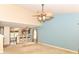 Open-concept living room with a ceiling fan, a view into the kitchen and lots of natural light at 3067 Stilton Dr, Cicero, IN 46034