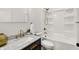 Bathroom with marble countertops, and shower/tub combo with bronze fixtures at 35 N Keystone Ave, Indianapolis, IN 46201