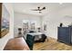 Bedroom with wood floors, natural light, dark dresser, and ceiling fan at 35 N Keystone Ave, Indianapolis, IN 46201