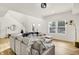 Bright and airy living room with a large sectional sofa and hardwood floors at 35 N Keystone Ave, Indianapolis, IN 46201