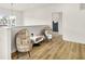Upstairs landing area featuring two decorative chairs, wood floors and natural lighting at 35 N Keystone Ave, Indianapolis, IN 46201
