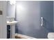 Bathroom features a pedestal sink, ample lighting, and handicap bars at 4223 Kestrel Ct, Indianapolis, IN 46254