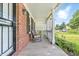 Inviting front porch showcasing brick siding, rocking chairs, and verdant landscaping at 4223 Kestrel Ct, Indianapolis, IN 46254