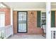 Charming front porch featuring brick siding, black shutters, and a decorative welcome mat at 4223 Kestrel Ct, Indianapolis, IN 46254