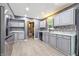 Well-lit kitchen with gray cabinets, modern appliances, and a charming window view at 4223 Kestrel Ct, Indianapolis, IN 46254