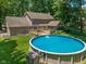 A large backyard with an above ground pool, deck, and mature trees at 429 Glenbrook Ln, Avon, IN 46123