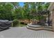 Multi-level wooden deck with seating, grill, and nearby above-ground pool surrounded by lush greenery at 429 Glenbrook Ln, Avon, IN 46123