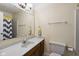 Neutral-toned bathroom with large mirror, vanity, and shower at 429 Glenbrook Ln, Avon, IN 46123