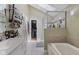 Modern bathroom with tiled floors, tub and shower combo, and closet at 429 Glenbrook Ln, Avon, IN 46123