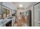 A long kitchen space with stainless steel appliances and a view to the backyard at 429 Glenbrook Ln, Avon, IN 46123