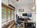 Sunlit home office with large window, desk, and wall art at 429 Glenbrook Ln, Avon, IN 46123