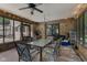 Enclosed porch featuring brick accents, outdoor seating, and sliding glass doors at 429 Glenbrook Ln, Avon, IN 46123