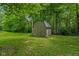 Backyard storage shed situated on a lush green lawn surrounded by trees at 429 Glenbrook Ln, Avon, IN 46123
