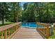 Backyard above ground swimming pool with ladder and surrounded by mature trees at 429 Glenbrook Ln, Avon, IN 46123