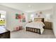 Bright bedroom featuring shiplap walls, neutral tones, charming decor, and ample natural light from the windows at 4379 Red Pine Dr, Bargersville, IN 46106