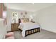 Bright bedroom featuring shiplap walls, neutral tones, charming decor, and ample natural light from the windows at 4379 Red Pine Dr, Bargersville, IN 46106