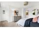 Bright bedroom with plush bed, modern dresser, neutral walls and decor, and doorway leading to additional rooms at 4379 Red Pine Dr, Bargersville, IN 46106