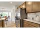 Kitchen view showcasing stainless steel refrigerator, granite countertops, and light wood cabinets at 4379 Red Pine Dr, Bargersville, IN 46106