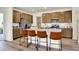 Stylish kitchen with an island with barstools, stainless appliances, granite countertops, and lots of cabinet space at 4379 Red Pine Dr, Bargersville, IN 46106