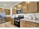 A well-equipped kitchen with stainless appliances, granite countertops, and wood-look flooring at 4379 Red Pine Dr, Bargersville, IN 46106