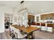 Open concept kitchen and dining area with modern lighting and a spacious wooden dining table at 4379 Red Pine Dr, Bargersville, IN 46106
