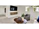 Bright living room with mounted TV, cozy seating, and natural lighting from a window at 4379 Red Pine Dr, Bargersville, IN 46106