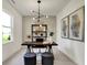 Modern home office with a stylish desk, unique lighting, and minimalist decor at 4379 Red Pine Dr, Bargersville, IN 46106