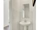 Bright powder room features tiled walls, a pedestal sink, and a sleek mirror at 4379 Red Pine Dr, Bargersville, IN 46106