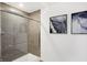 Modern tiled shower with glass door next to a wall featuring an art print at 4382 Red Pine Dr, Bargersville, IN 46106