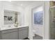 Bright bathroom featuring double sink vanity with white countertop and modern faucets, as well as a glass-enclosed shower at 4382 Red Pine Dr, Bargersville, IN 46106