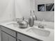 Bathroom vanity features dual sinks, modern faucets, decorative vases, and bright white countertops at 4382 Red Pine Dr, Bargersville, IN 46106