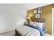 Well-lit bedroom features comfortable queen bed, industrial nightstand, and bright yellow accent wall at 4382 Red Pine Dr, Bargersville, IN 46106