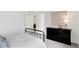 Bright bedroom features a black dresser with decorative art, a black bed frame, and neutral tones at 4382 Red Pine Dr, Bargersville, IN 46106
