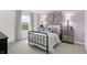 Light-filled bedroom showcases a black metal frame bed and picturesque window views at 4382 Red Pine Dr, Bargersville, IN 46106