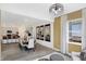 Open concept dining room with gray chairs, modern chandelier, and hardwood flooring at 4382 Red Pine Dr, Bargersville, IN 46106