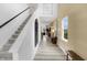 Inviting foyer with stairway, wood-look flooring, and stylish decor leading to an open-concept living space at 4382 Red Pine Dr, Bargersville, IN 46106
