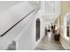 Bright foyer featuring a staircase with wood banister and a decorative mirror highlighting the home's design at 4382 Red Pine Dr, Bargersville, IN 46106