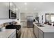 Modern kitchen features stainless steel appliances, a center island, and sleek gray cabinets at 4382 Red Pine Dr, Bargersville, IN 46106