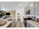Open kitchen design with a central island, pantry, stainless steel appliances, and seamless connection to living areas at 4382 Red Pine Dr, Bargersville, IN 46106
