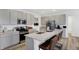 Modern kitchen featuring gray cabinets, stainless steel appliances, and a large island with bar stool seating at 4382 Red Pine Dr, Bargersville, IN 46106