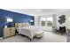 Comfortable main bedroom with blue accent wall, stylish lamps, and beautiful lake view at 4382 Red Pine Dr, Bargersville, IN 46106