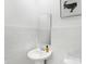 Clean, modern powder room featuring white subway tile, pedestal sink, and sleek mirror at 4382 Red Pine Dr, Bargersville, IN 46106