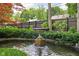 Water feature in the lush backyard features a pond with a stone fountain at 4455 Broadway St, Indianapolis, IN 46205