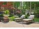 Serene backyard patio featuring comfortable lounge chairs and lush garden views at 4455 Broadway St, Indianapolis, IN 46205