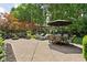 Expansive brick patio with outdoor dining and lounge area, surrounded by lush landscaping at 4455 Broadway St, Indianapolis, IN 46205