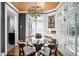 Bright breakfast nook featuring a glass table and a decorative chandelier at 4455 Broadway St, Indianapolis, IN 46205