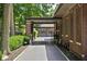 Long driveway leading to the garage and carport, lined with lush greenery and mature trees at 4455 Broadway St, Indianapolis, IN 46205