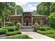 Charming brick home with a green tile roof, manicured front yard, and inviting entrance at 4455 Broadway St, Indianapolis, IN 46205