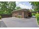Exterior of home features lush landscaping, a spacious driveway, and brick facade at 4455 Broadway St, Indianapolis, IN 46205